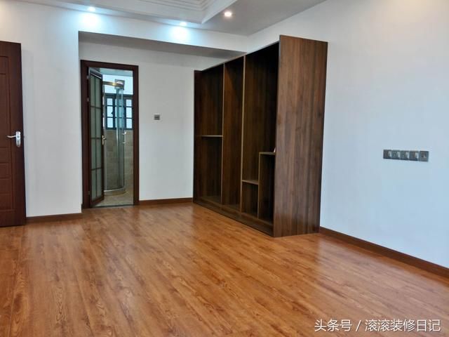 主卧采用浅色实木地板,开放式的深色衣柜储存空间较大,与深色门框相