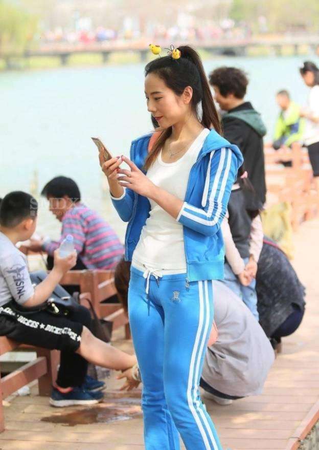 有一个姑娘,她很爱自拍,她还有一件蓝色运动裤.