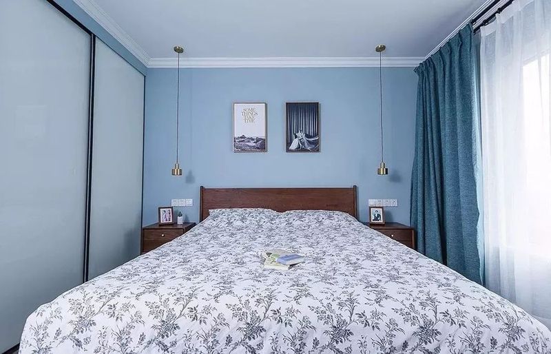 次卧同样以淡蓝色的空间为主,搭配上一张深木色的床与床头柜,书桌