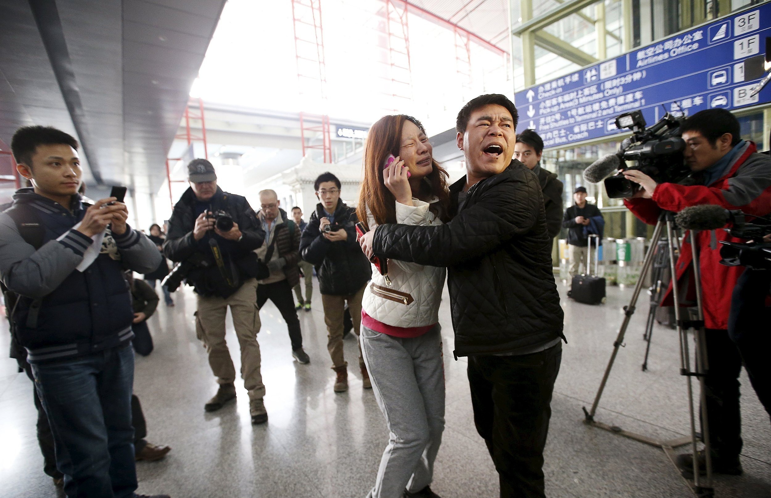 2014年3月8日，北京，一名马航MH370乘客的家属在首都机场一边打电话一边哭泣。MH370在当天凌晨与管制中心失去联系，机上有乘客和机组人员239人，其中包括154名中国乘客。