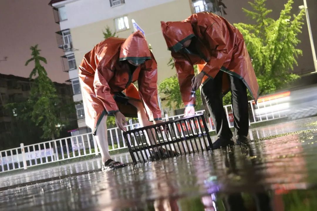 鼎顺嘉园社区志愿者大雨中及时清理水篦子