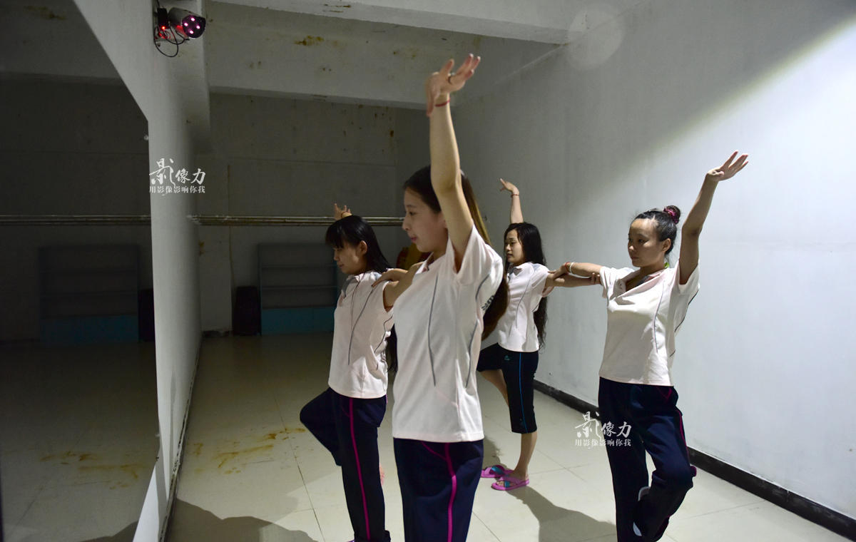 休息间隙,“美人鱼”姑娘们在镜子前练习舞蹈动作。