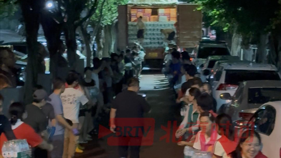在榕江，志愿者与当地居民接力运输物资，忙碌间隙齐喊 “榕江加油”